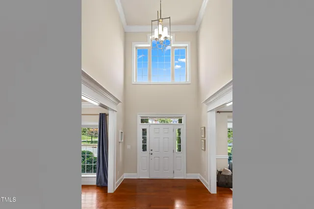 a view of a hallway with wooden floor and entryway