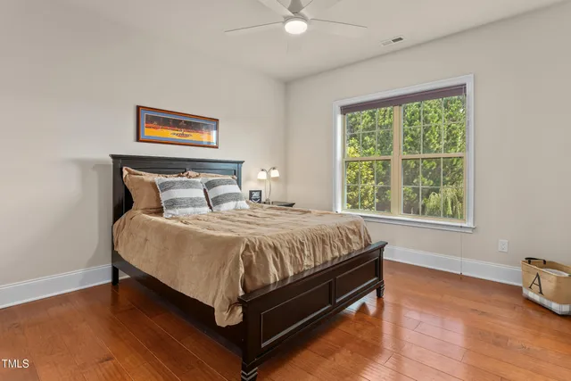 a bed sitting in a bedroom next to a window