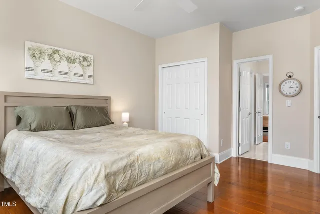 a bedroom with a bed and wooden floor