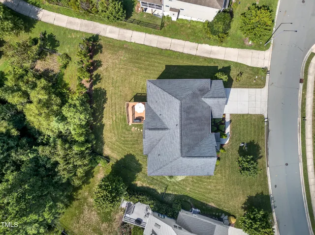 an aerial view of a house with a yard