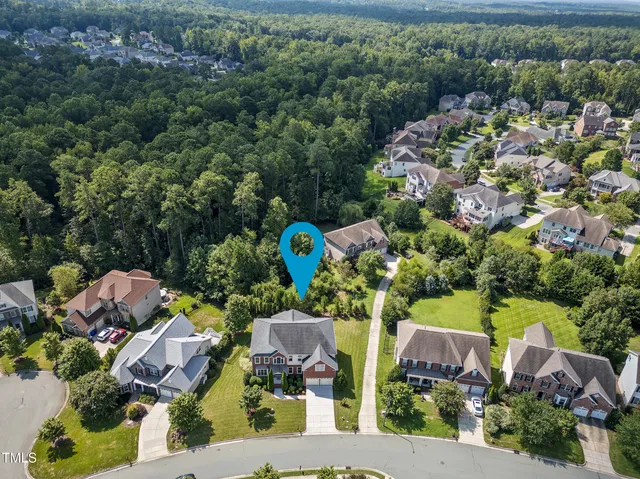 an aerial view of a house with a yard basket ball court and outdoor seating