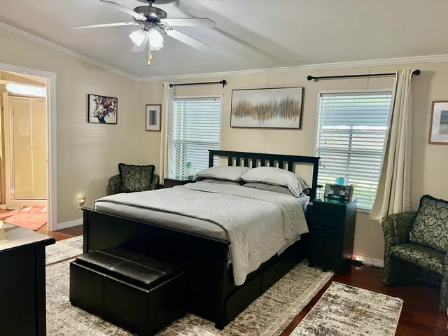 a bedroom with a bed and wooden floor