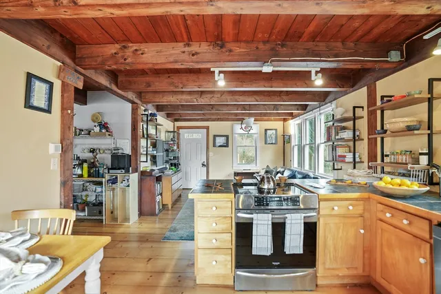 a kitchen with stainless steel appliances granite countertop a sink stove and wooden cabinets