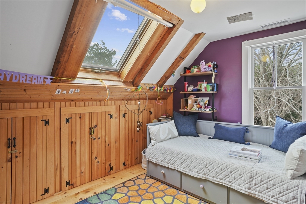 44 Planting Field Way Edgartown, MA 02539 - Photo 21 of 32 a bedroom with a bed and wooden floor