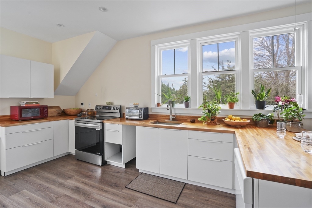44 Planting Field Way Edgartown, MA 02539 - Photo 28 of 32 a kitchen with a sink stove and cabinets