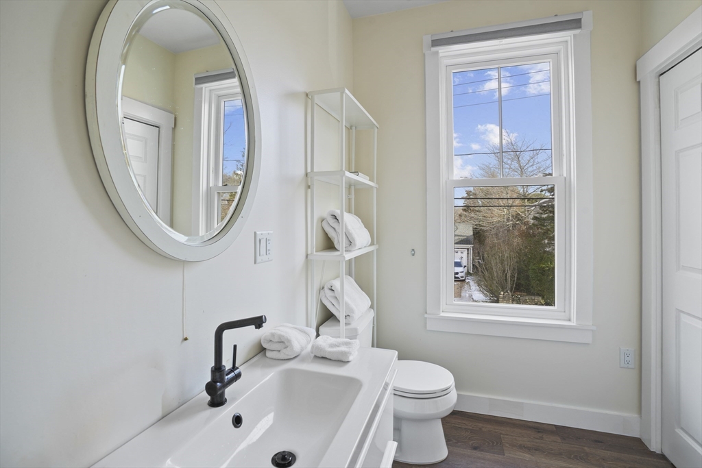 44 Planting Field Way Edgartown, MA 02539 - Photo 32 of 32 a bathroom with a sink and a mirror