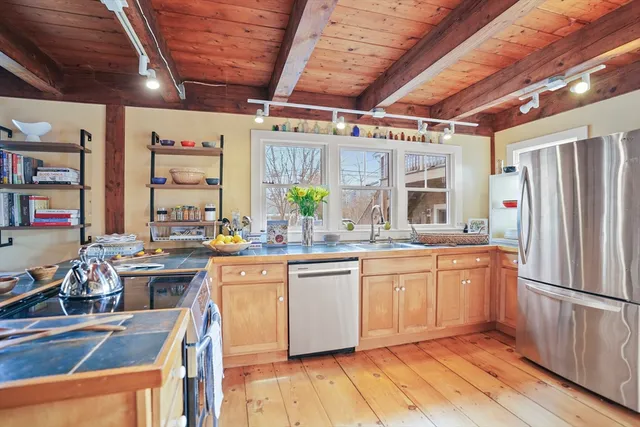 a kitchen with stainless steel appliances granite countertop a sink and stove top oven