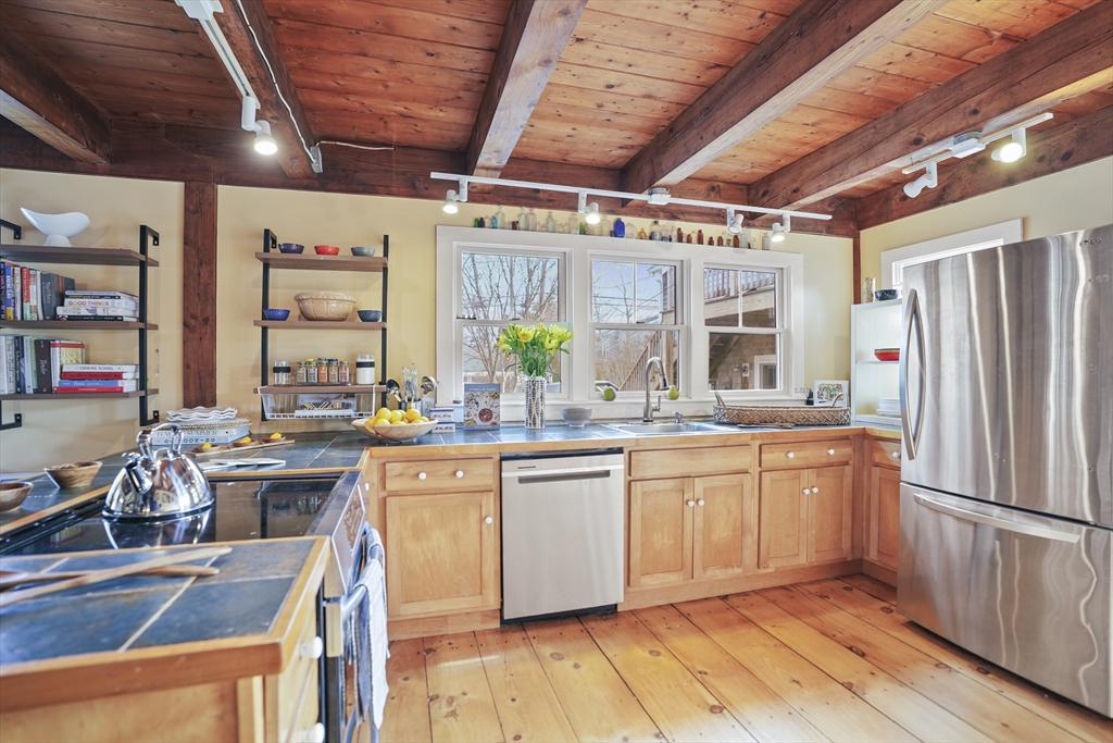 44 Planting Field Way Edgartown, MA 02539 - Photo 9 of 33 a kitchen with stainless steel appliances granite countertop a sink window and cabinets