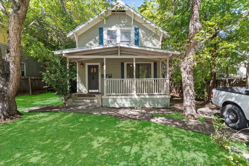 704 Franklin Boulevard, Unit A Austin, TX 78751 - Photo 1 of 12 a front view of a house with a garden and yard