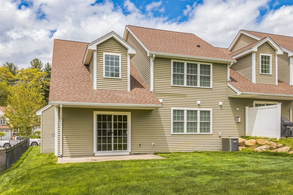 53 Baldwin Road, Unit 1401 Billerica, MA 01821 - Photo 3 of 32 a front view of a house with a yard