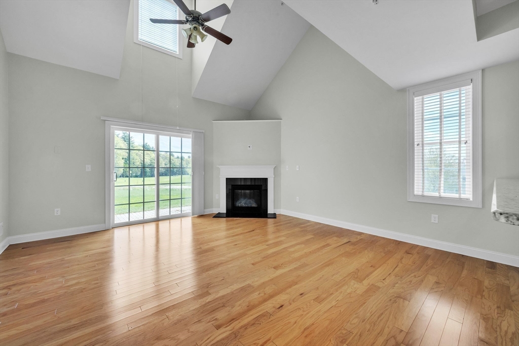 53 Baldwin Road, Unit 1401 Billerica, MA 01821 - Photo 8 of 32 wooden floor fireplace and windows in an empty room