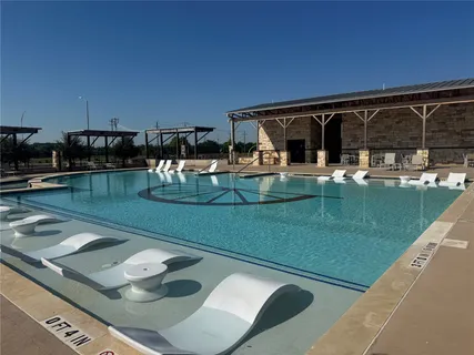 a view of a swimming pool with chairs