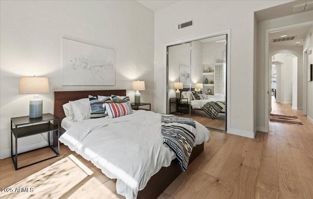 a bedroom with bed and a mirror