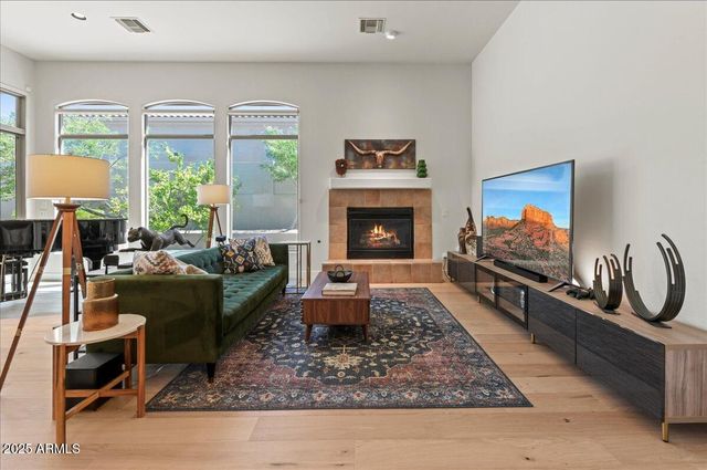 a living room with furniture flat screen tv and a fireplace