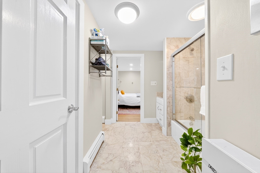 352 Tappan Street, Unit 1 Brookline, MA 02445 - Photo 20 of 42 a en suite bathroom with a granite countertop shower
