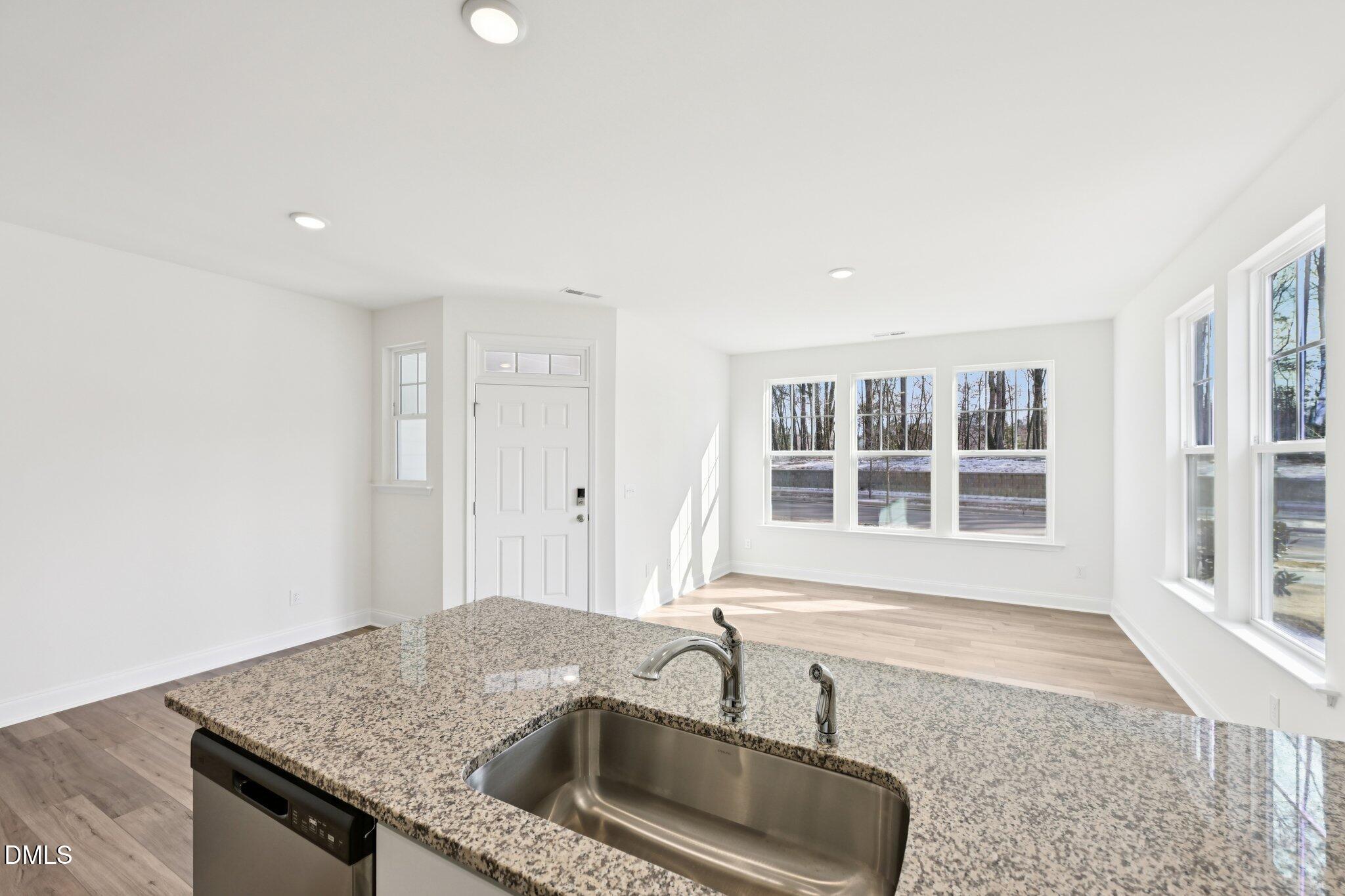 6429 Granite Quarry Drive Raleigh, NC 27610 - Photo 12 of 64 a kitchen with granite countertop a sink and a window