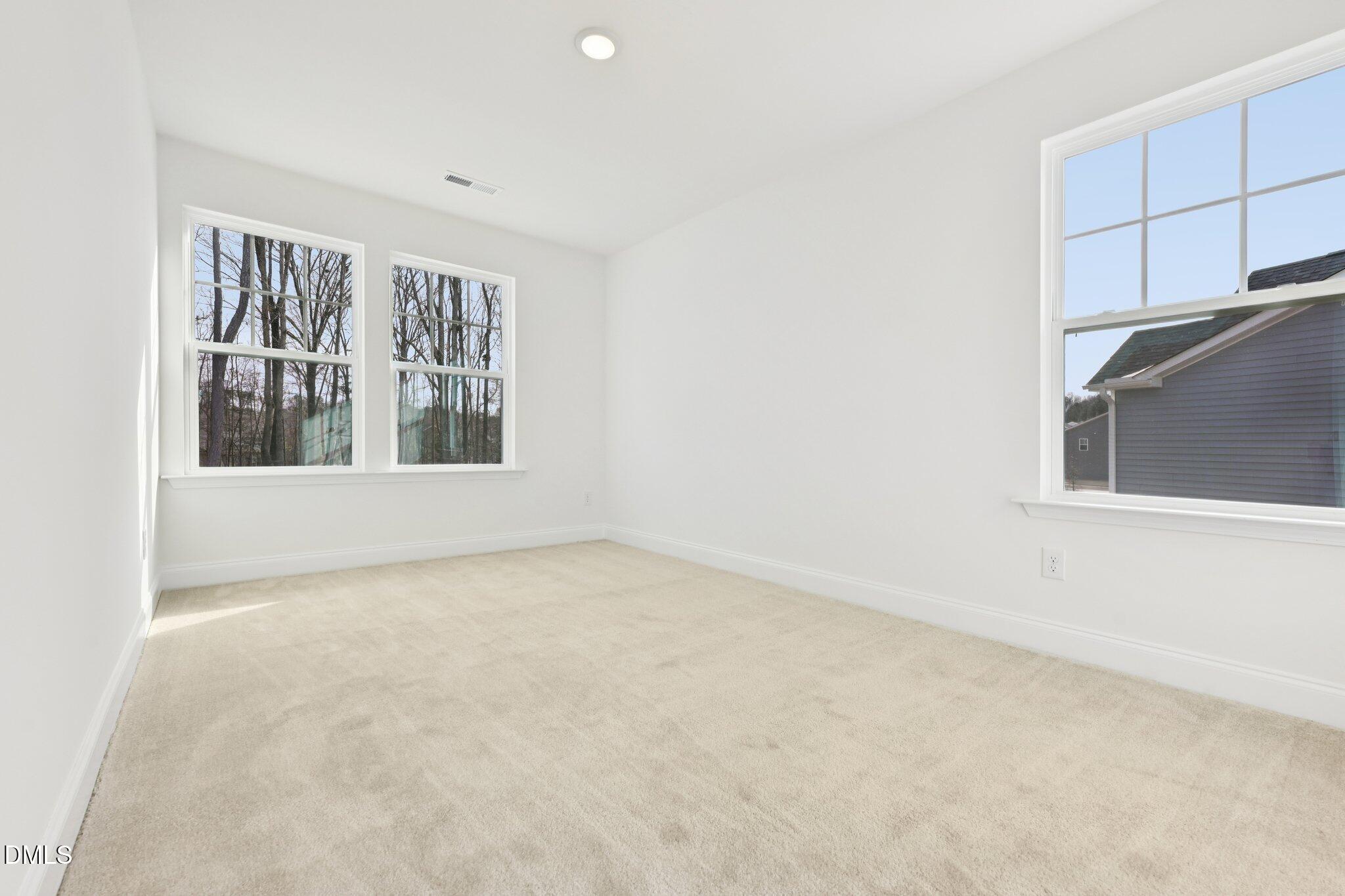 6429 Granite Quarry Drive Raleigh, NC 27610 - Photo 17 of 64 a view of an empty room with a window