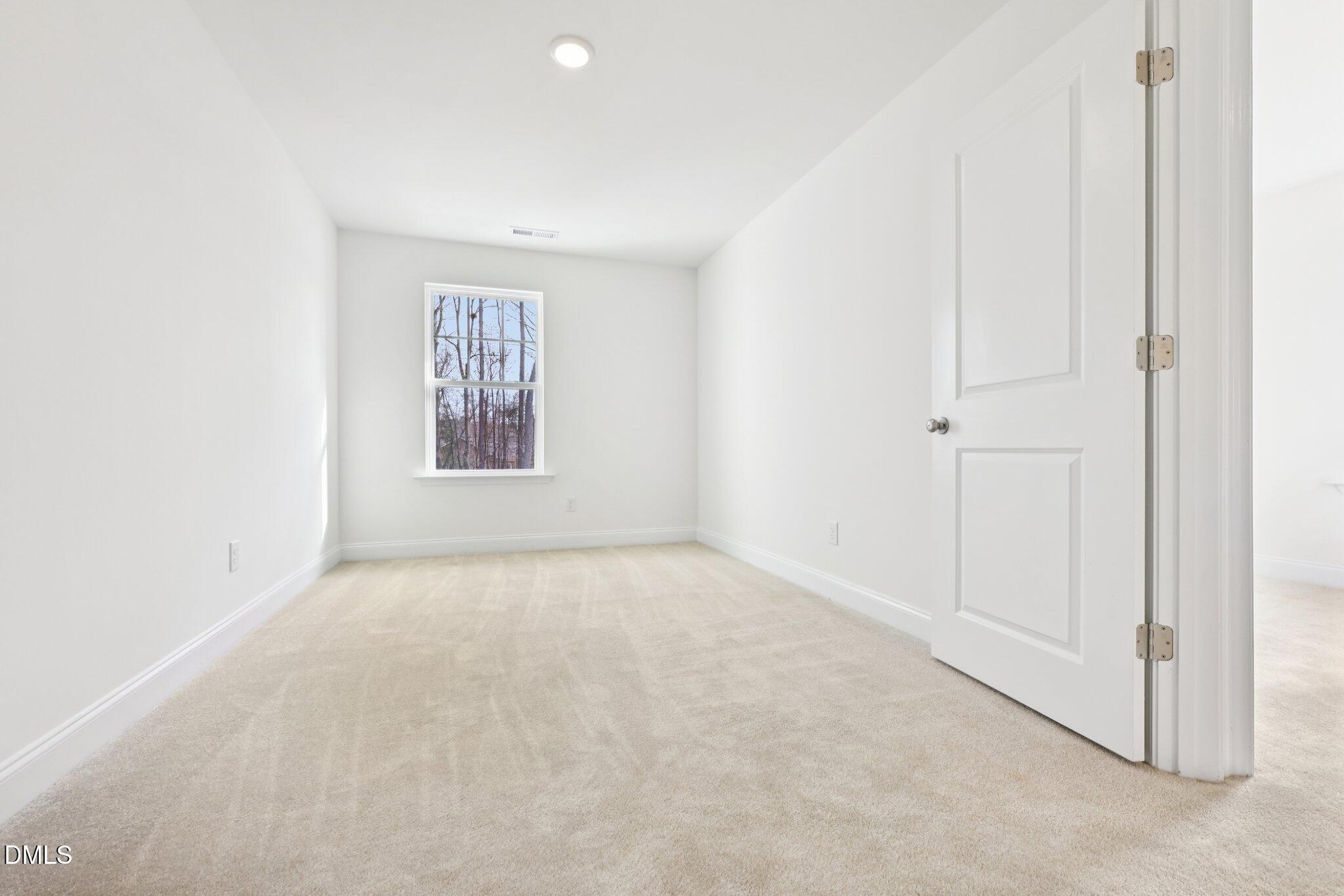 6429 Granite Quarry Drive Raleigh, NC 27610 - Photo 18 of 64 an empty room with windows and closet