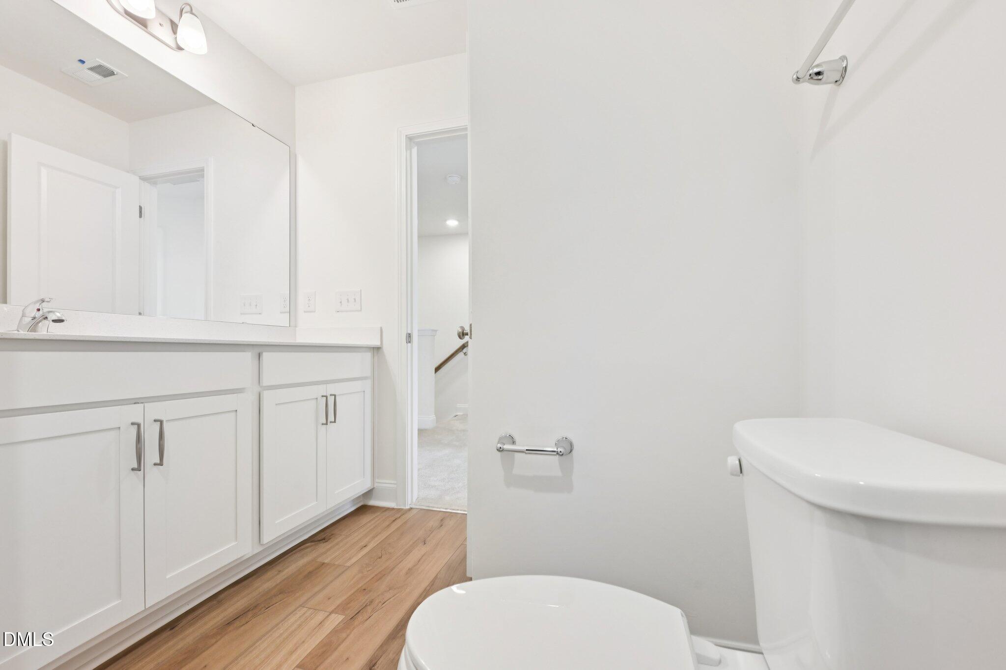 6429 Granite Quarry Drive Raleigh, NC 27610 - Photo 20 of 64 a white toilet sitting next to a bathroom sink