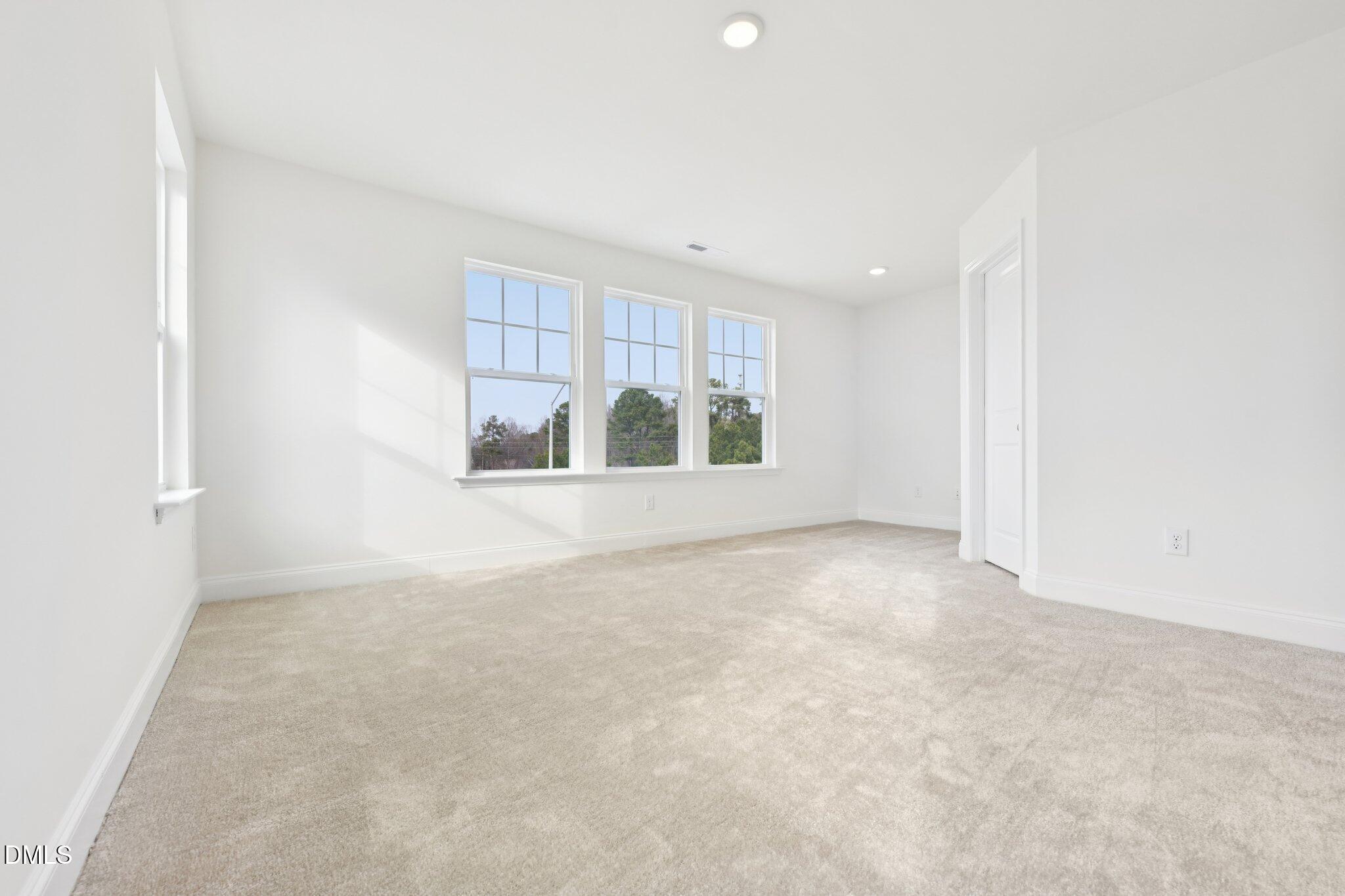6429 Granite Quarry Drive Raleigh, NC 27610 - Photo 22 of 64 an empty room with a windows and closet