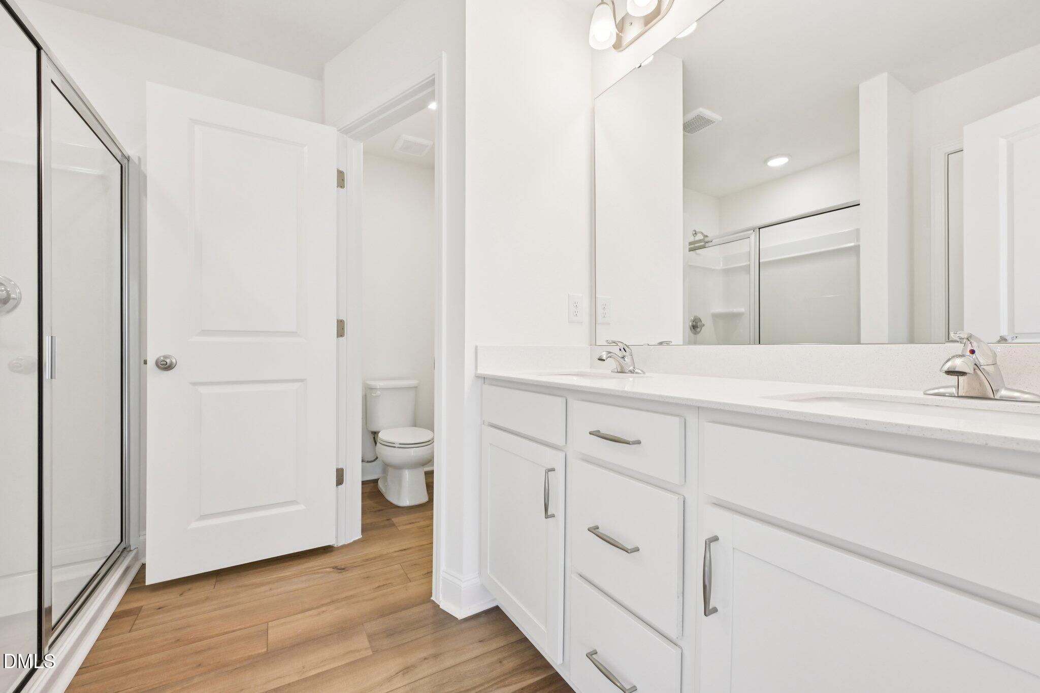 6429 Granite Quarry Drive Raleigh, NC 27610 - Photo 25 of 64 a spacious bathroom with a double vanity sink mirror and toilet