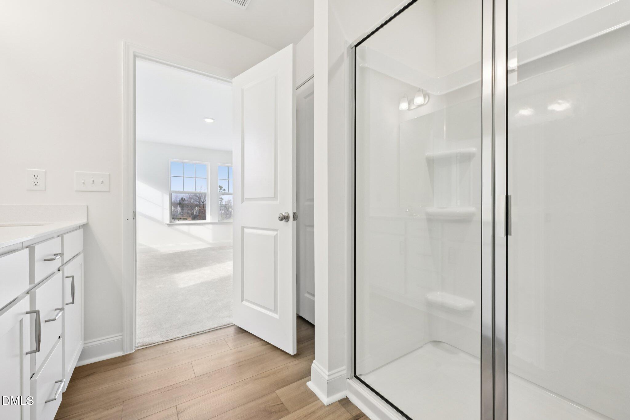 6429 Granite Quarry Drive Raleigh, NC 27610 - Photo 26 of 64 a bathroom with a glass shower door
