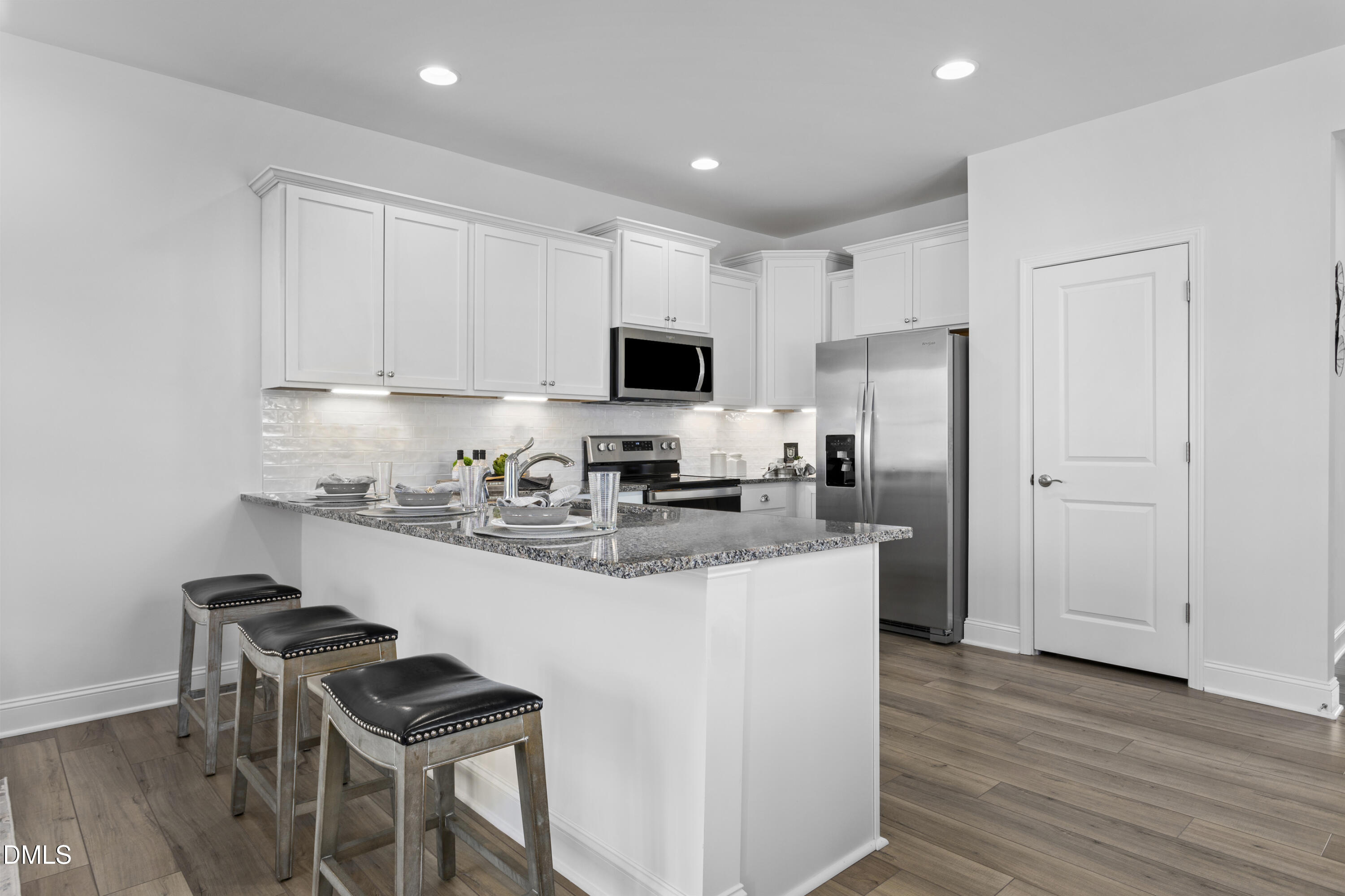 6429 Granite Quarry Drive Raleigh, NC 27610 - Photo 32 of 64 a kitchen with stainless steel appliances granite countertop a stove top oven a refrigerator a sink and a microwave