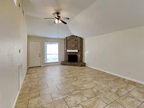 a view of an empty room with a fireplace