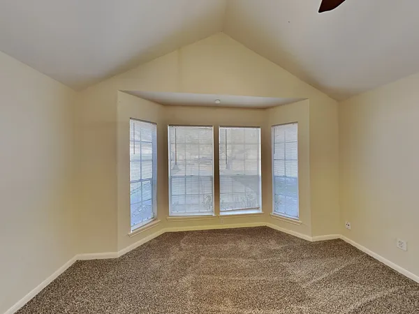 a view of an empty room with a fan