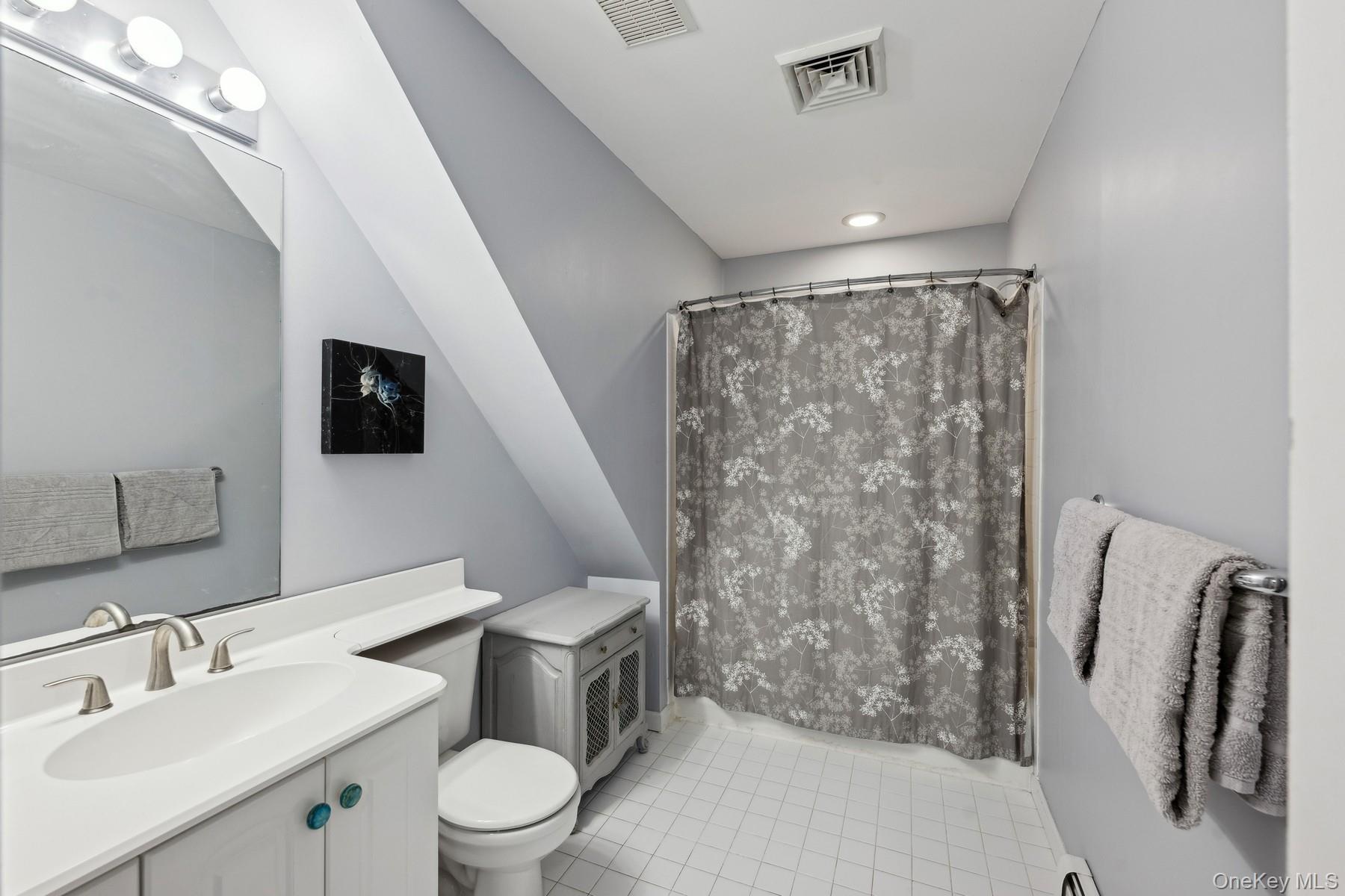12 Hildreth Road Hampton Bays, NY 11946 - Photo 18 of 21 Bathroom featuring tile patterned floors, vanity, toilet, and walk in shower