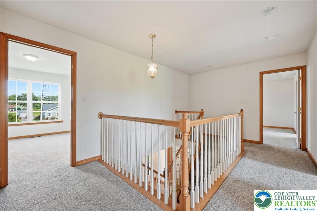 66 Labar Road Bangor, PA 18013 - Photo 21 of 56 A well-lit second-story landing features light wood handrails and soft carpeting leading to spacious rooms.