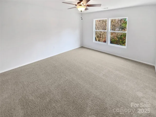 a spacious bathroom with a tub sink and a mirror