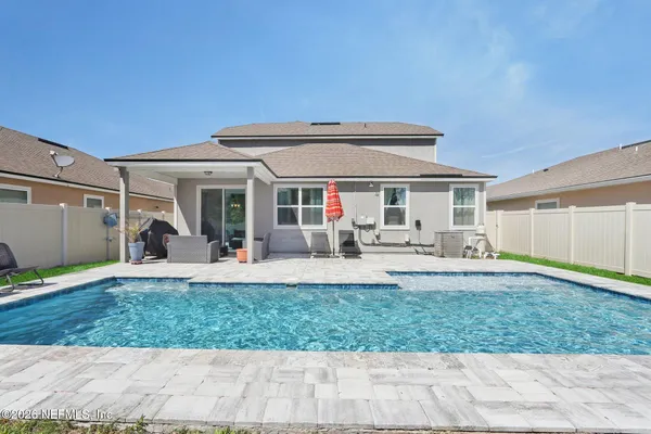 a view of a house with backyard porch and sitting area