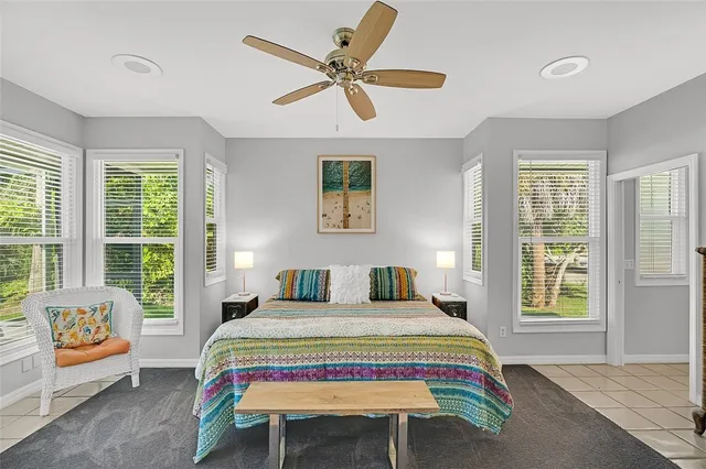 a bedroom with a bed a table and a chandelier