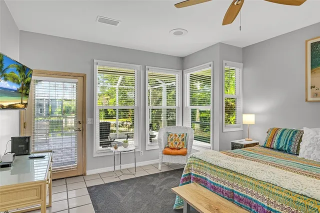 a living room with furniture and a floor to ceiling window