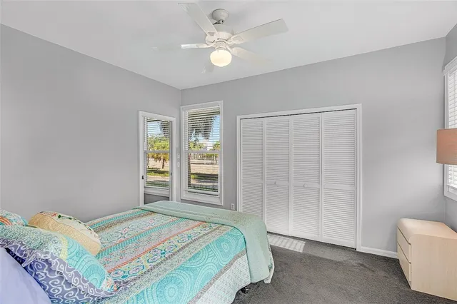 a bedroom with a bed closet and a window