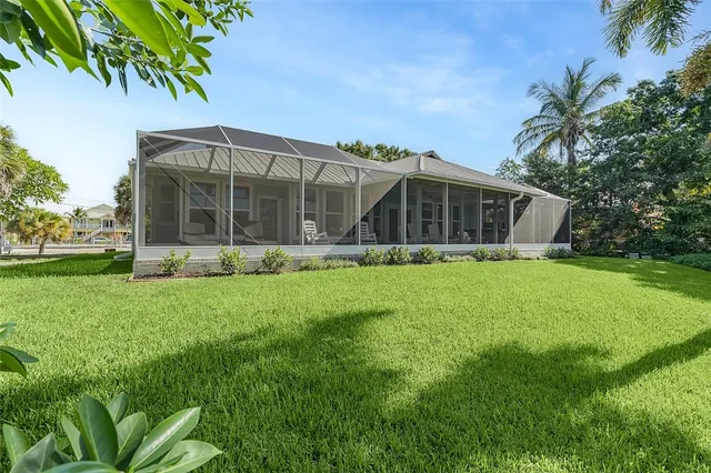 a view of a house with yard and sitting area