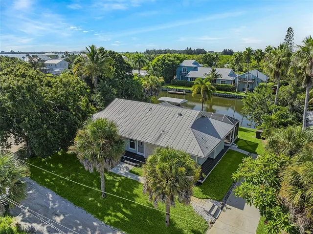 a view of a house with a yard and lake view