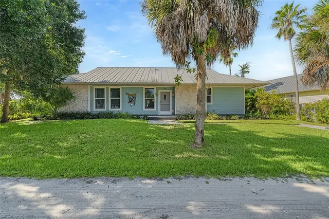 a house that has a tree in front of it