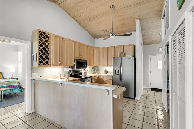 a kitchen with stainless steel appliances a refrigerator a sink a stove a microwave a counter top space and cabinets