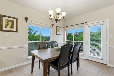 a view of a dining room with furniture wooden floor and chandelier