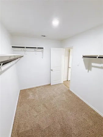 a view of a room with closet and racks on the wall