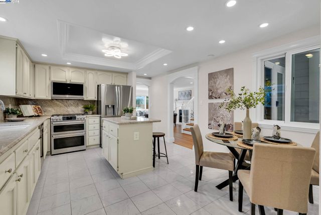 a view of a livingroom with wooden floor and staircase