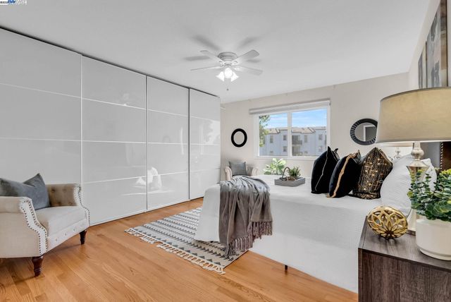 a bed room with a bed and a lamp on dresser