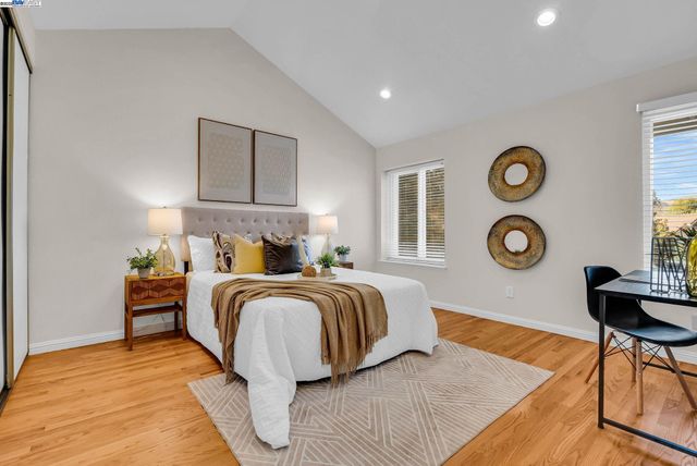 a bathroom with a granite countertop sink and a large mirror