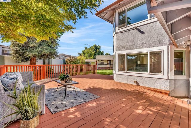 a view of a house with fountain plants and large trees