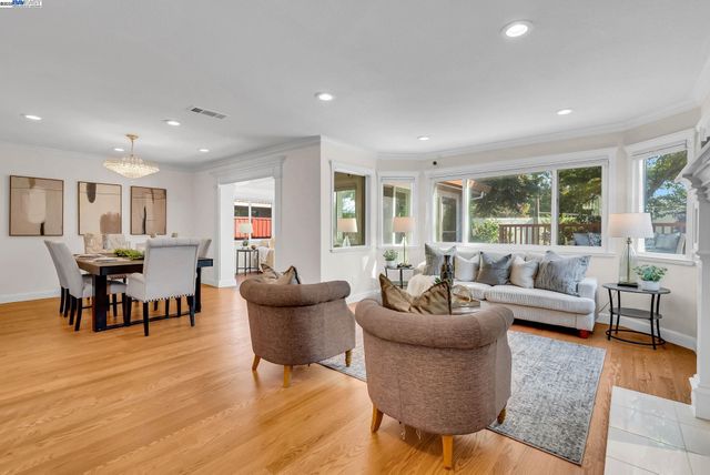 a living room with furniture kitchen view and a table