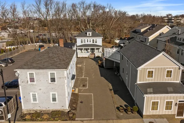 an aerial view of a building with streets and trees