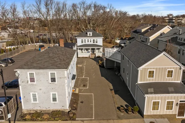 an aerial view of a building with streets and trees