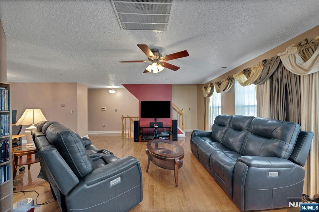 72 Marrow Street, Unit 3101 Newark, NJ 07103 - Photo 7 of 20 a living room with furniture and a flat screen tv with wooden floor